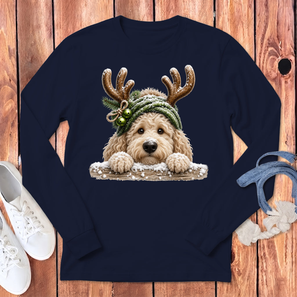 Goldendoodle wearing reindeer antlers and green hat with bells on navy shirt.