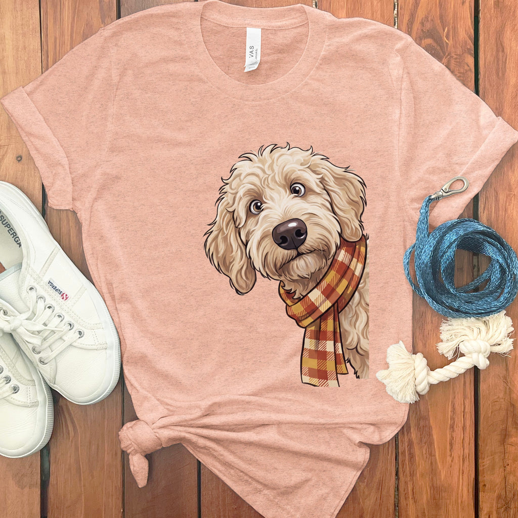 T-shirt with a cartoon drawing of a light-colored dog wearing a plaid scarf.
