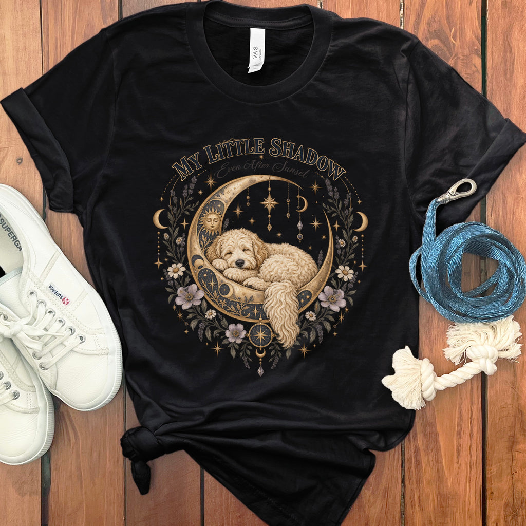 Black t-shirt with a golden crescent moon graphic featuring a sleeping dog and celestial motifs.