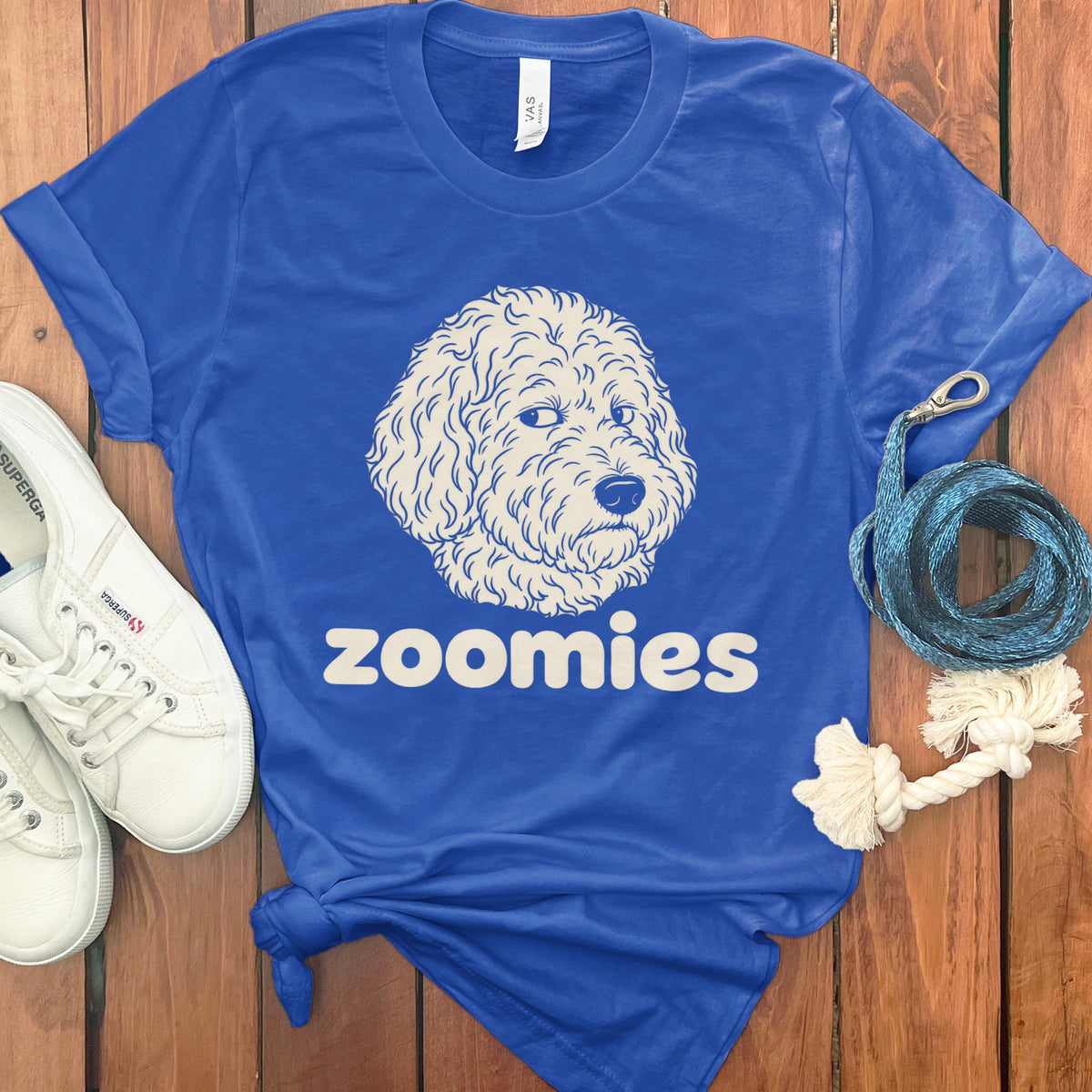 Royal blue t-shirt with a cream doodle dog graphic and "zoomies" text.