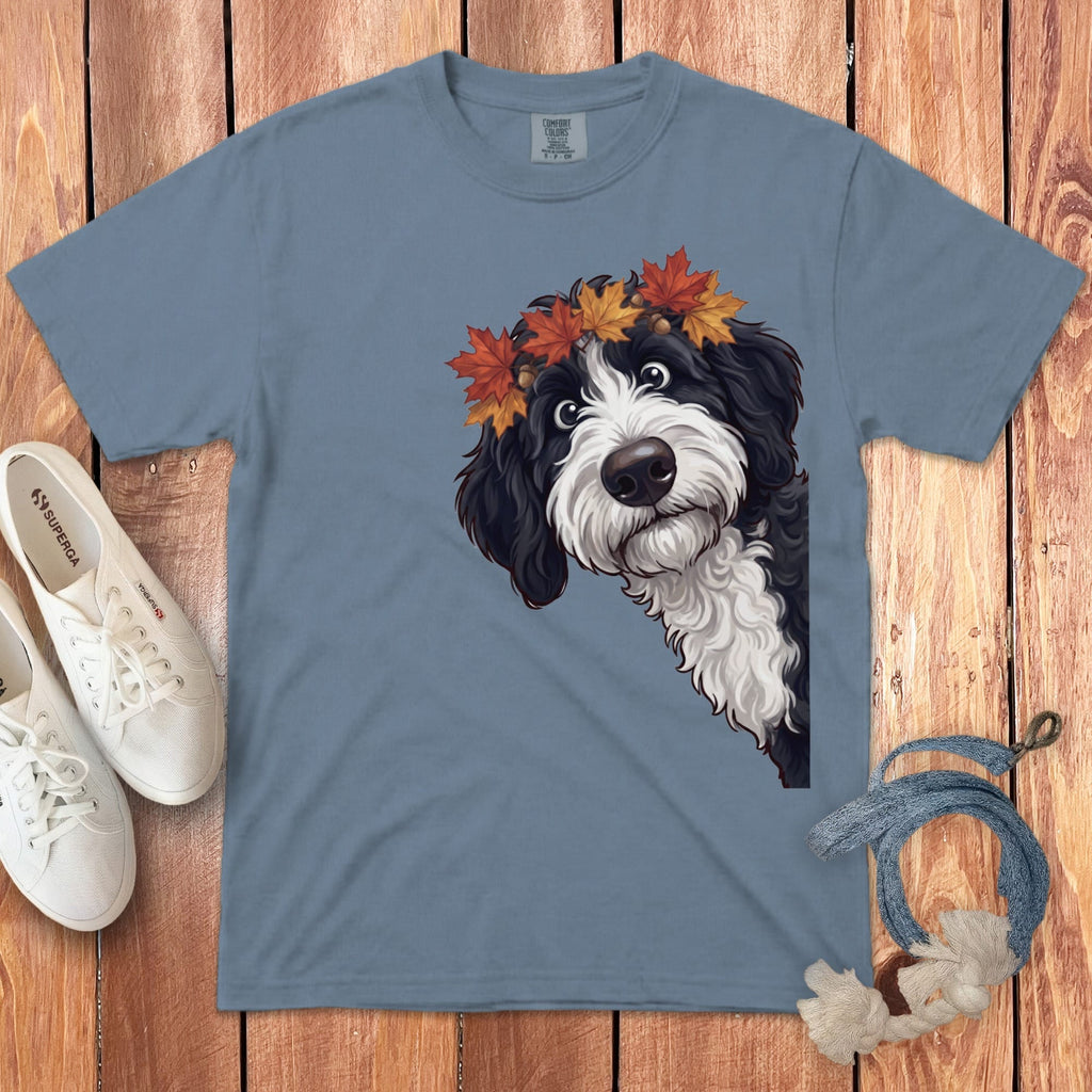 Dog wearing autumn leaf crown on blue t-shirt, white shoes, and rope detail.