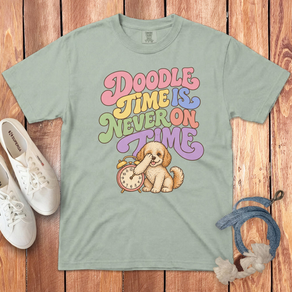 Light green t-shirt with retro text reading "Doodle Time Is Never On Time" and a puppy beside an alarm clock.