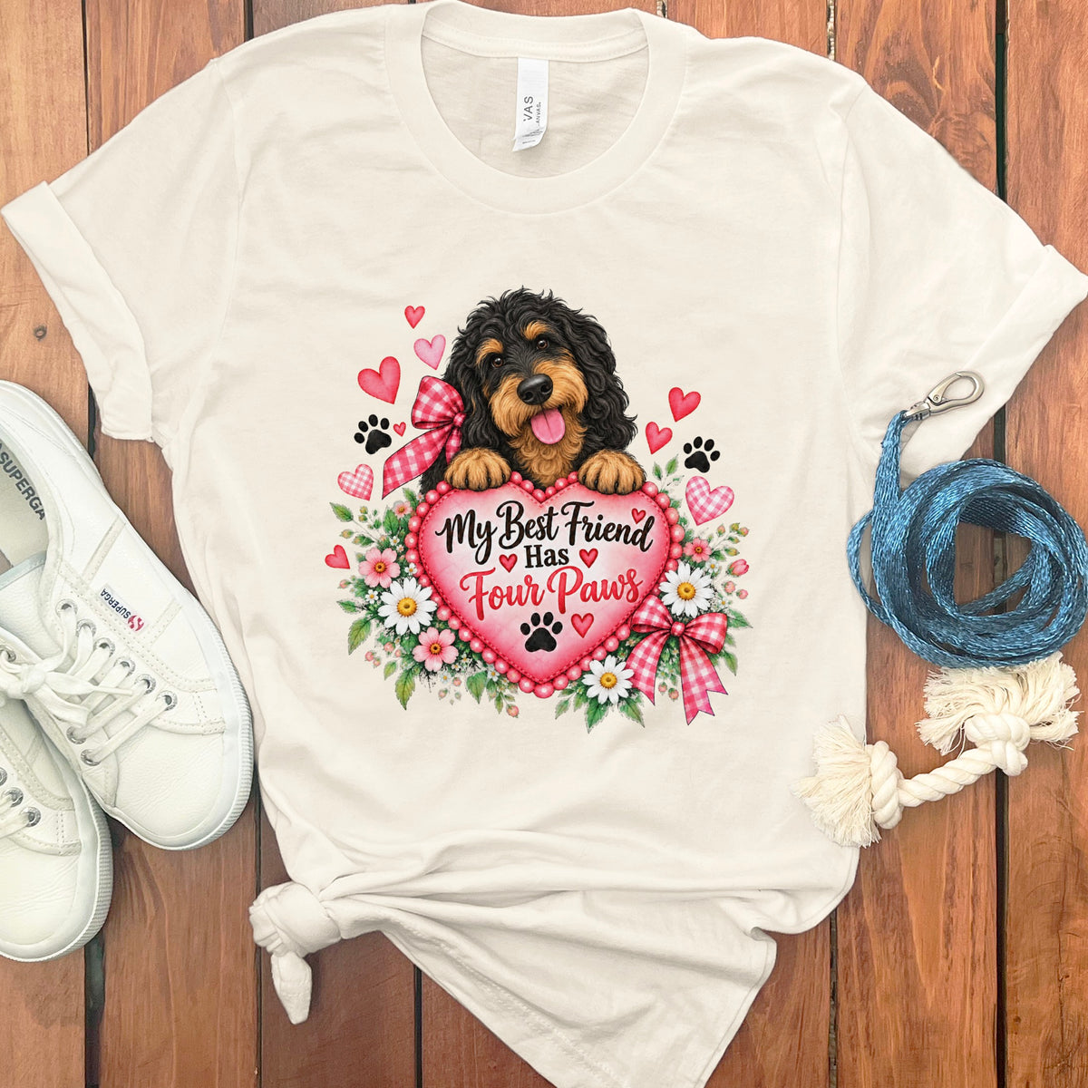 Off-white t-shirt with a graphic of a black and tan dog behind a heart with text.