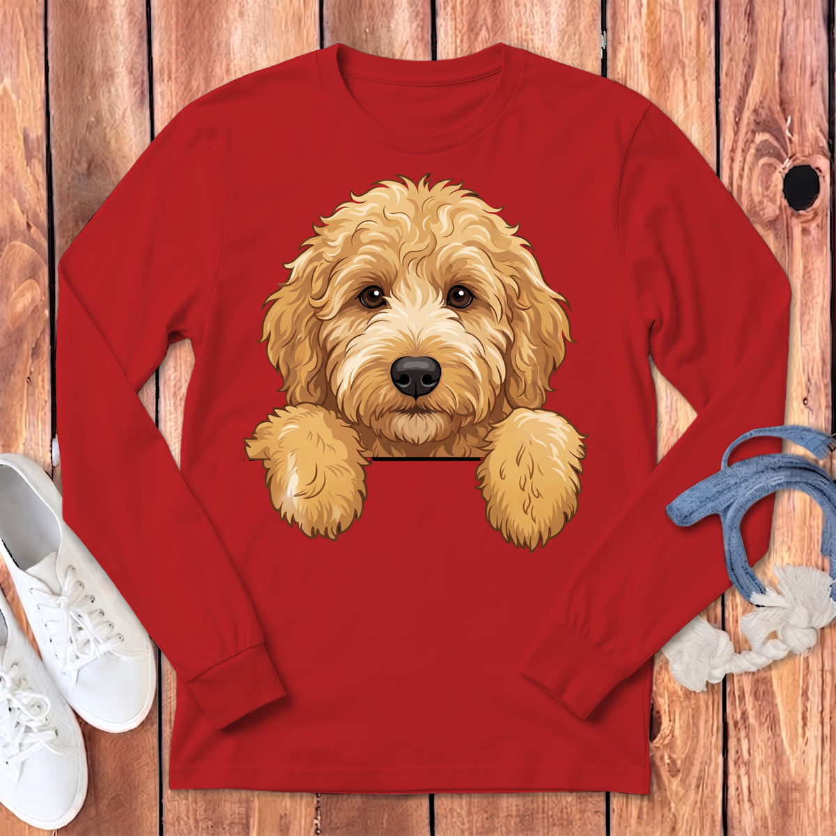 Red long-sleeve shirt with a graphic of a fluffy goldendoodle peeking over a black line.