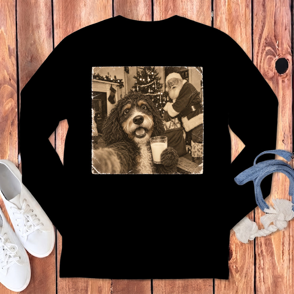 Black long-sleeve t-shirt featuring a retro graphic of a fluffy dog holding a glass of milk with Santa Claus in the background.