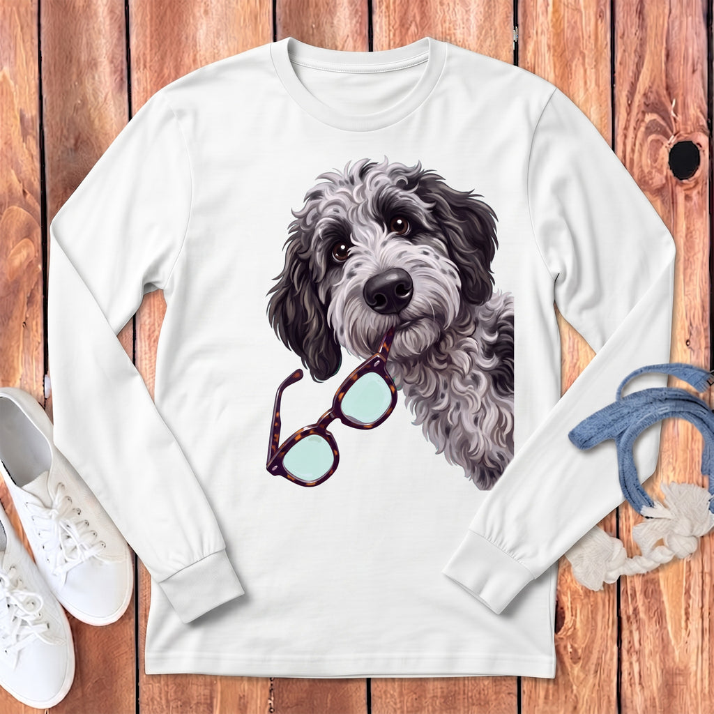 A white long-sleeved shirt features a graphic of a fluffy dog holding glasses in its mouth.