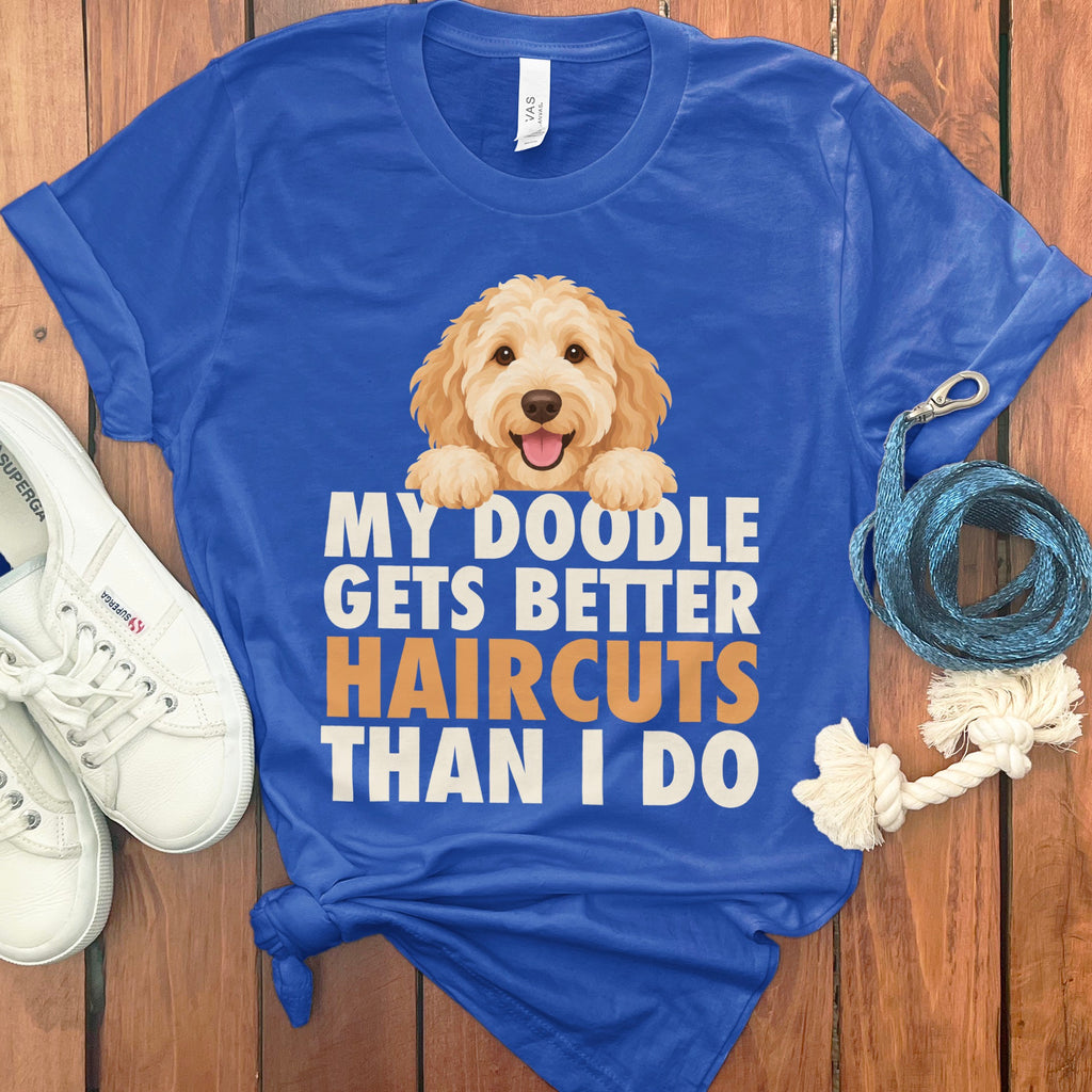 Blue t-shirt with a doodle dog graphic and text "MY DOODLE GETS BETTER HAIRCUTS THAN I DO".