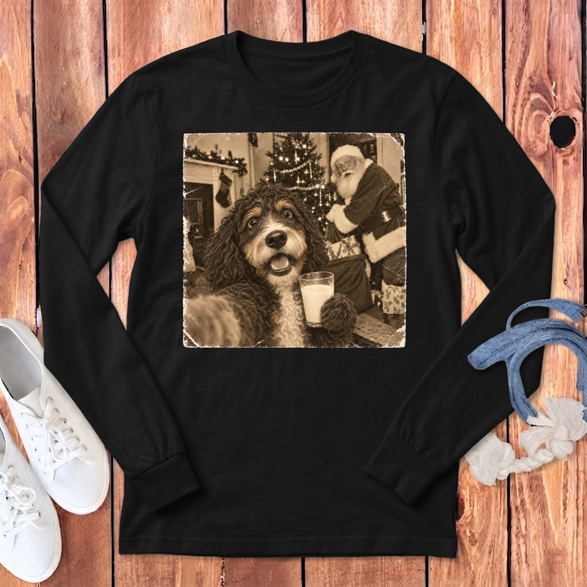 Black long-sleeve t-shirt featuring a sepia-toned graphic of a dog holding a glass of milk with Santa Claus in the background.