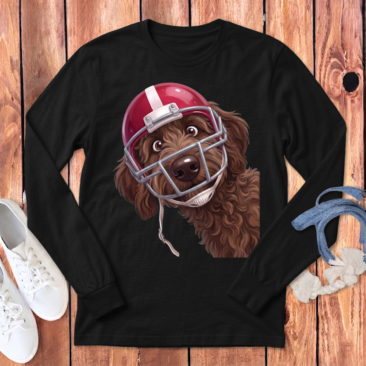 Black long-sleeve t-shirt featuring a graphic of a brown doodle dog wearing a red football helmet.