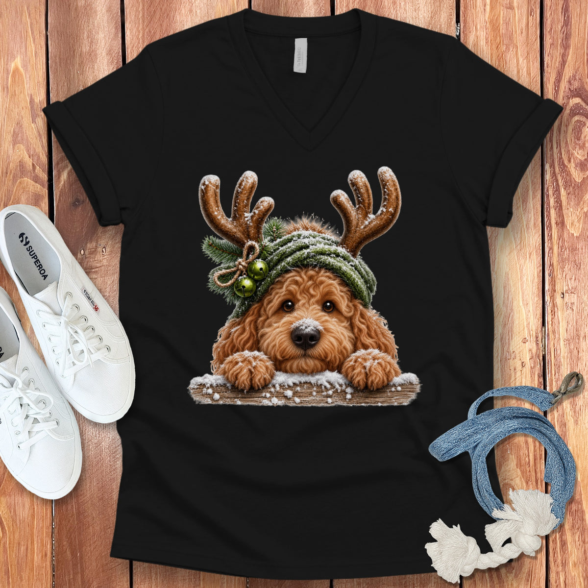 Black t-shirt with a fluffy dog wearing antlers and a green scarf.