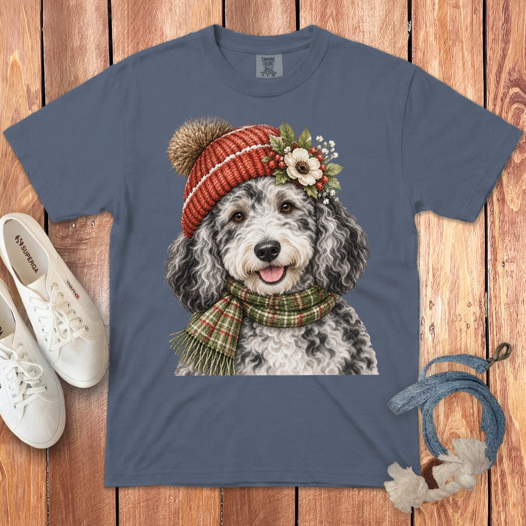 T-shirt with watercolor art of a fluffy dog wearing a red beanie and plaid scarf.