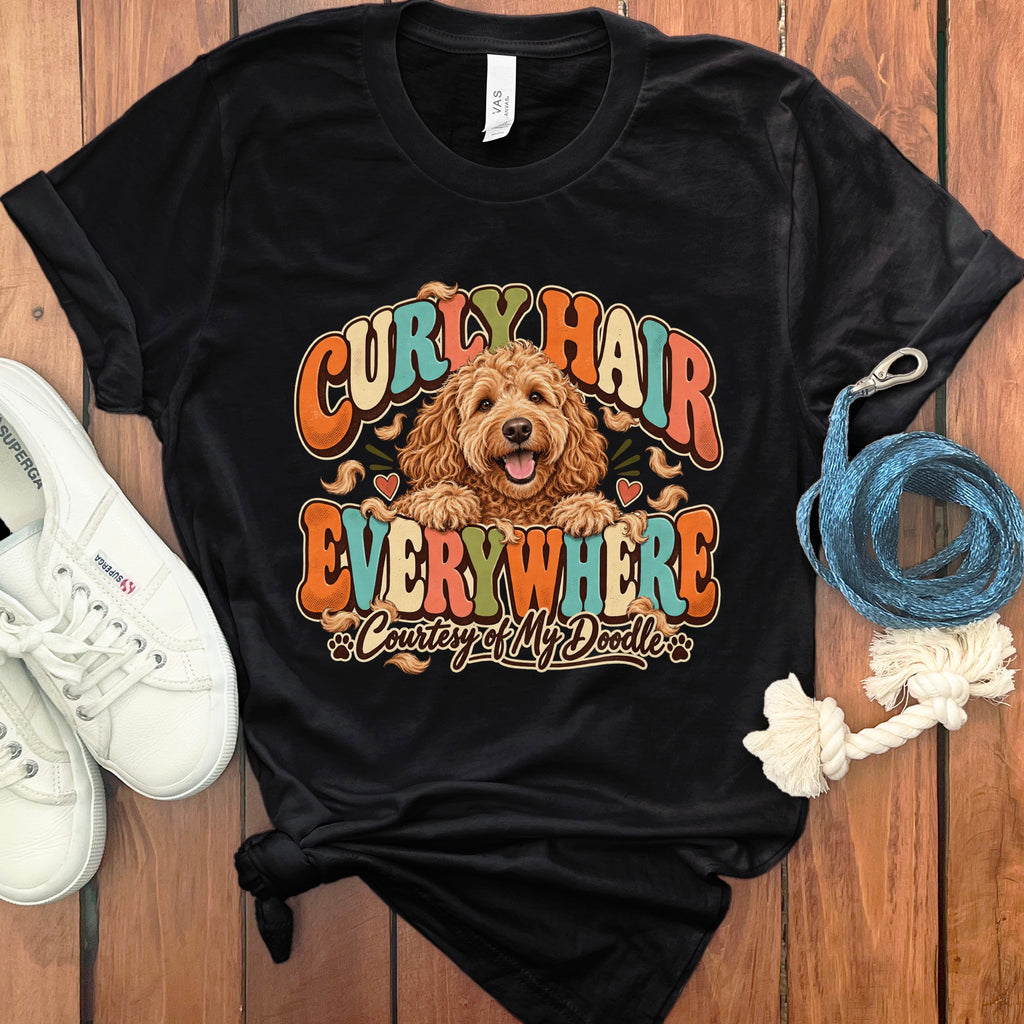 Black t-shirt with a goldendoodle and text "Curly Hair Everywhere Courtesy of My Doodle."