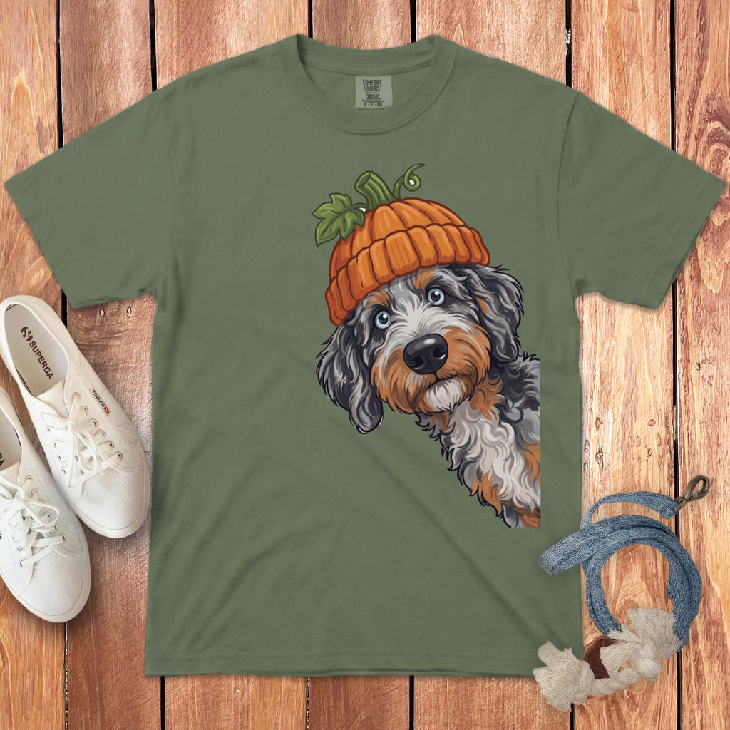 Green t-shirt with illustration of dog wearing pumpkin hat and white sneakers