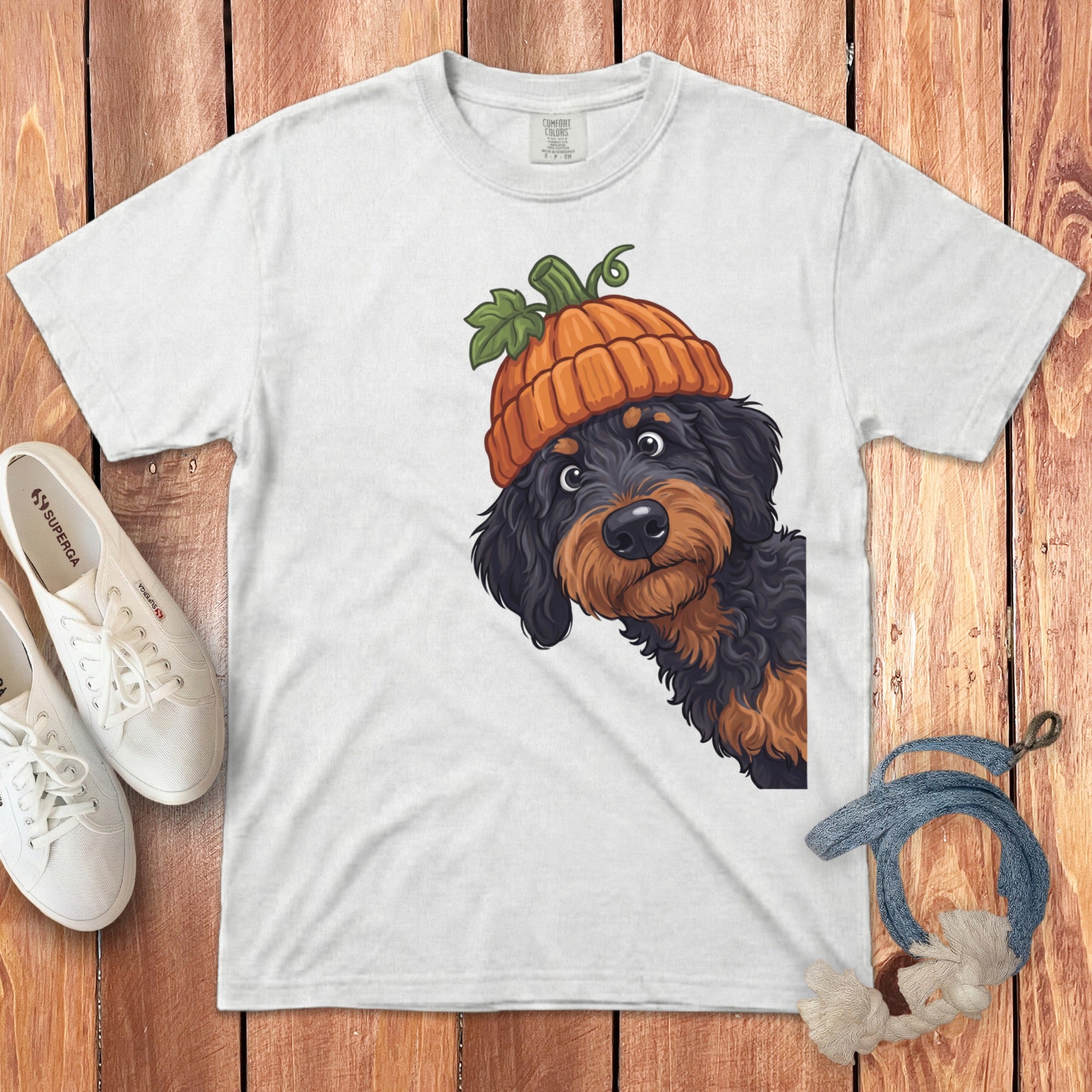 White t-shirt with a doodle dog wearing a pumpkin hat graphic.