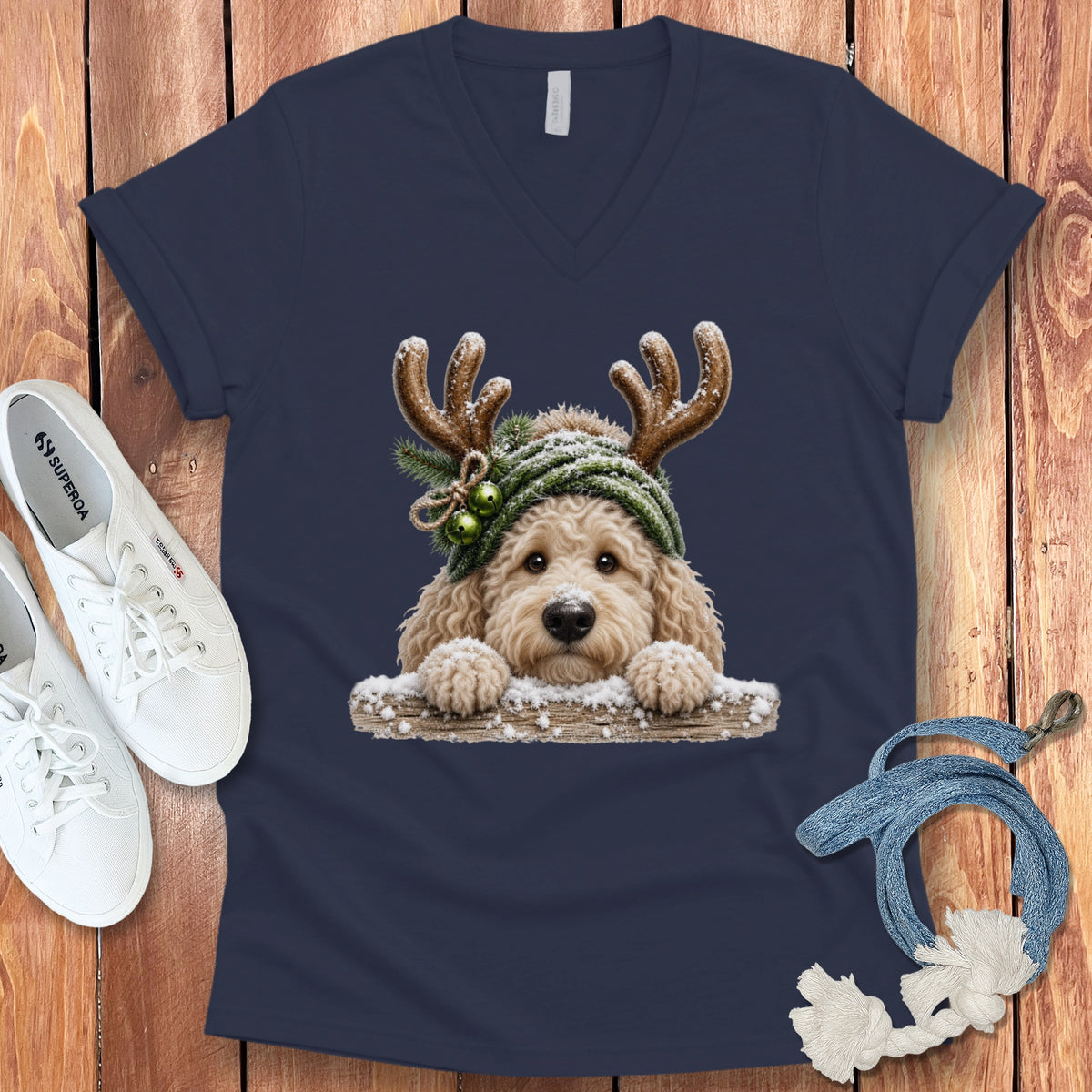 Fluffy dog with antlers and snow on a navy t-shirt.