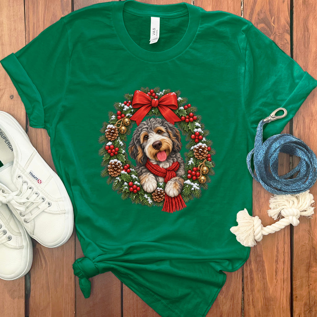A green t-shirt features a graphic of a fluffy dog inside a Christmas wreath.