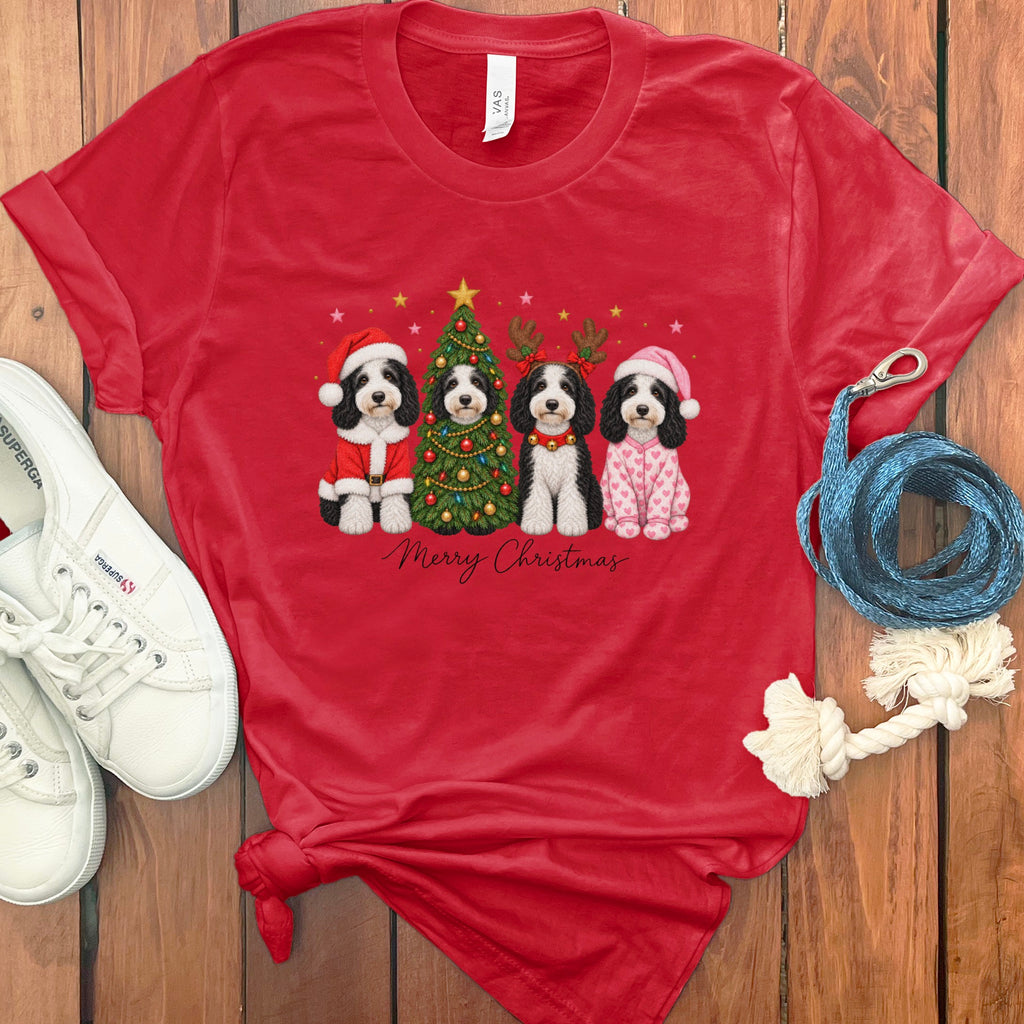 A red crewneck t-shirt featuring a graphic of four dogs dressed in holiday costumes with a Christmas tree.