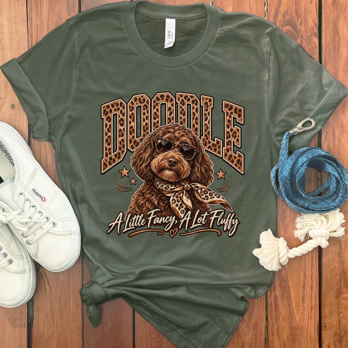 Green t-shirt with a doodle dog wearing sunglasses and a scarf, text says "Doodle A Little Fancy, A Lot Fluffy".
