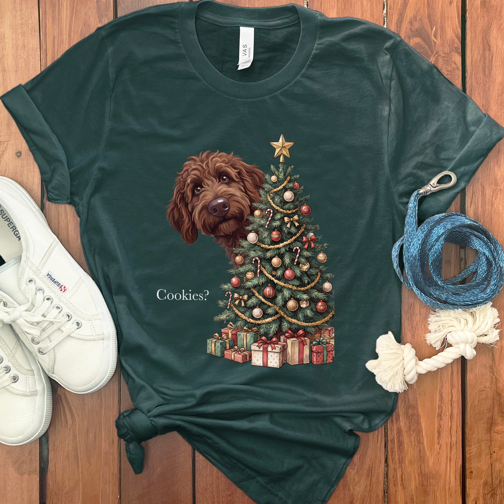 Dark green t-shirt with a doodle dog peeking at a Christmas tree and the text "Cookies?"