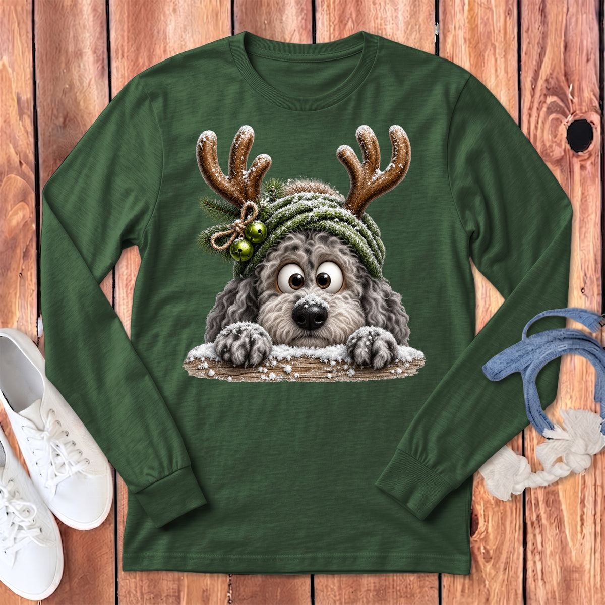 Green long-sleeve shirt with a fluffy dog wearing reindeer antlers and a hat.