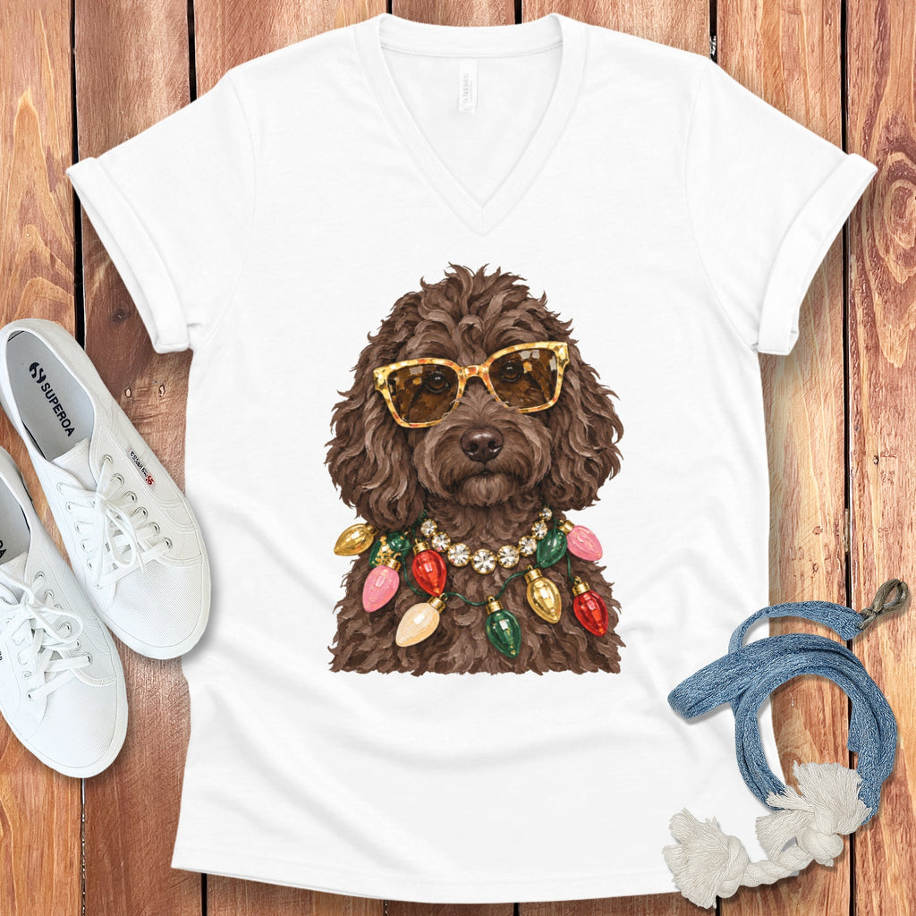 Brown poodle wearing gold sunglasses and a Christmas light necklace.