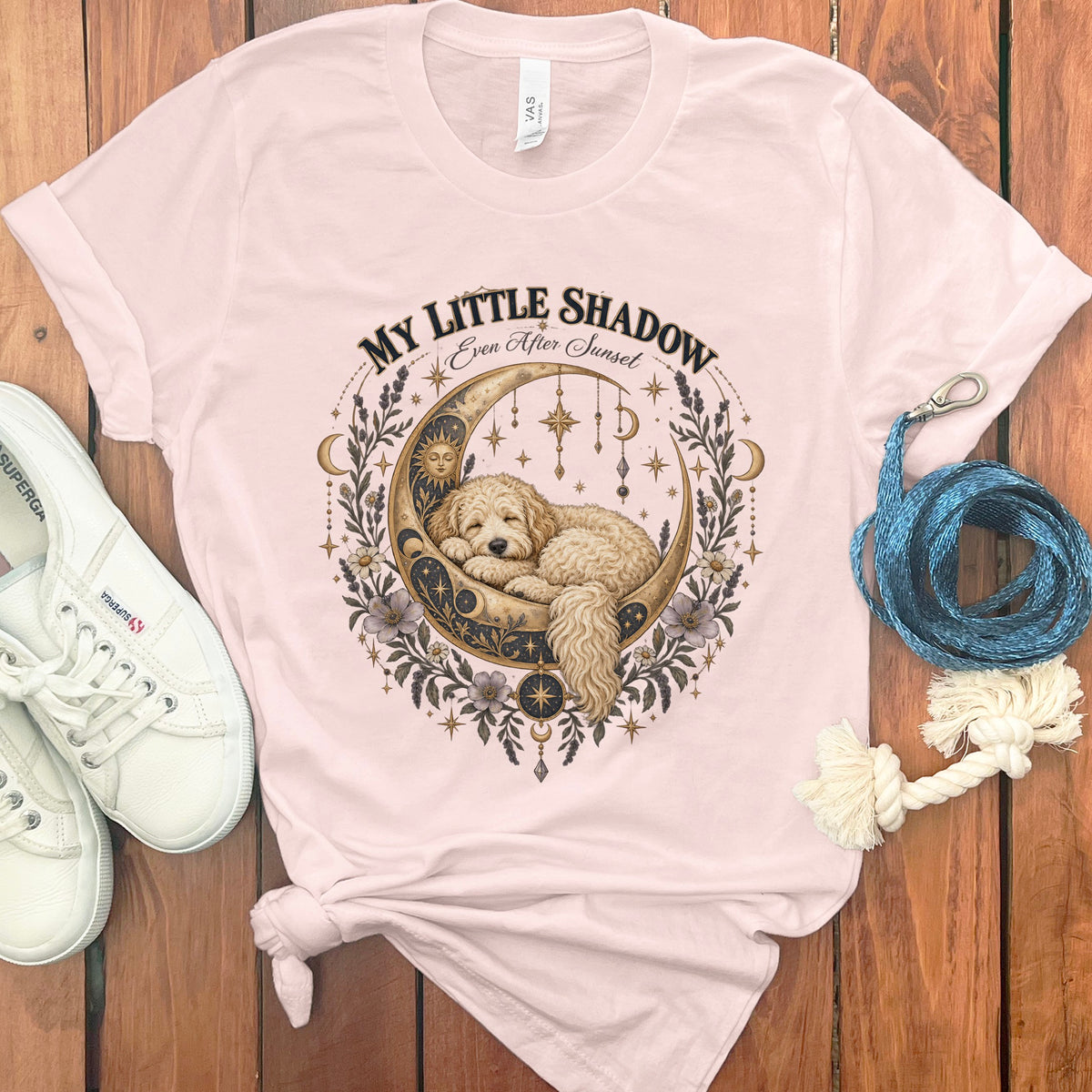 Pink t-shirt with graphic of dog sleeping on crescent moon with text "MY LITTLE SHADOW".