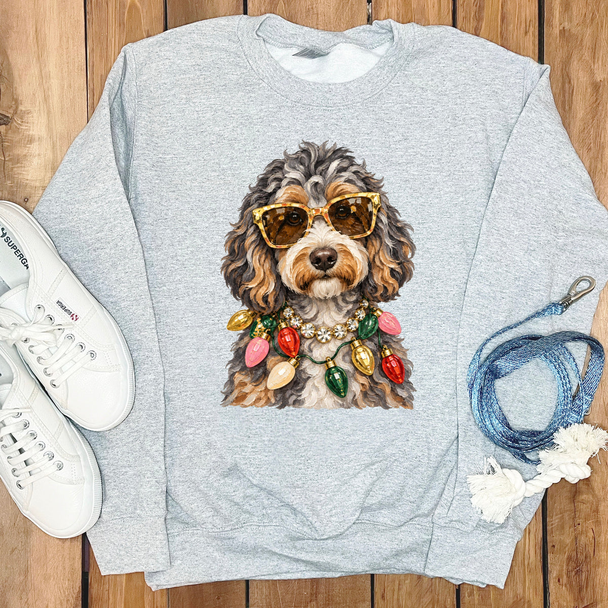 Gray sweatshirt with a drawing of a dog wearing sunglasses and a Christmas light necklace.