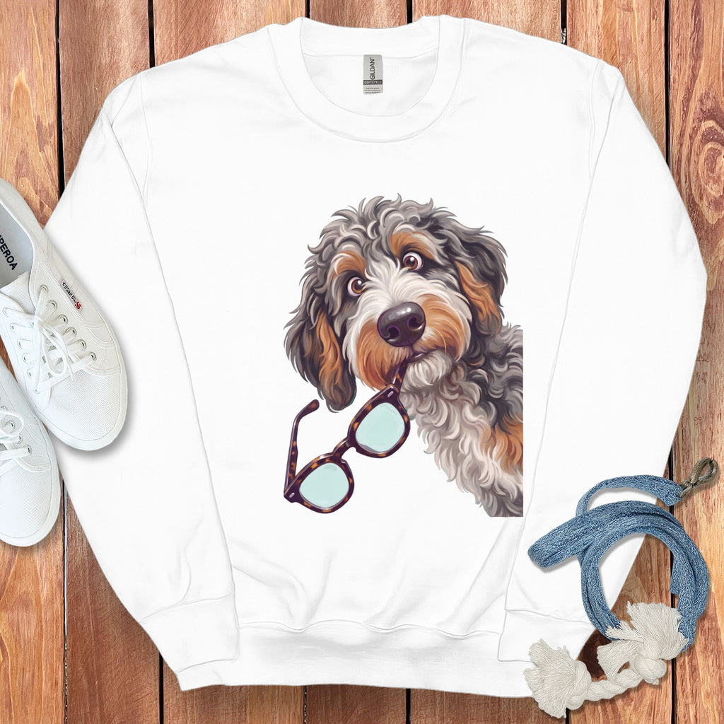 White crewneck sweatshirt featuring a graphic of a fluffy dog holding glasses in its mouth.