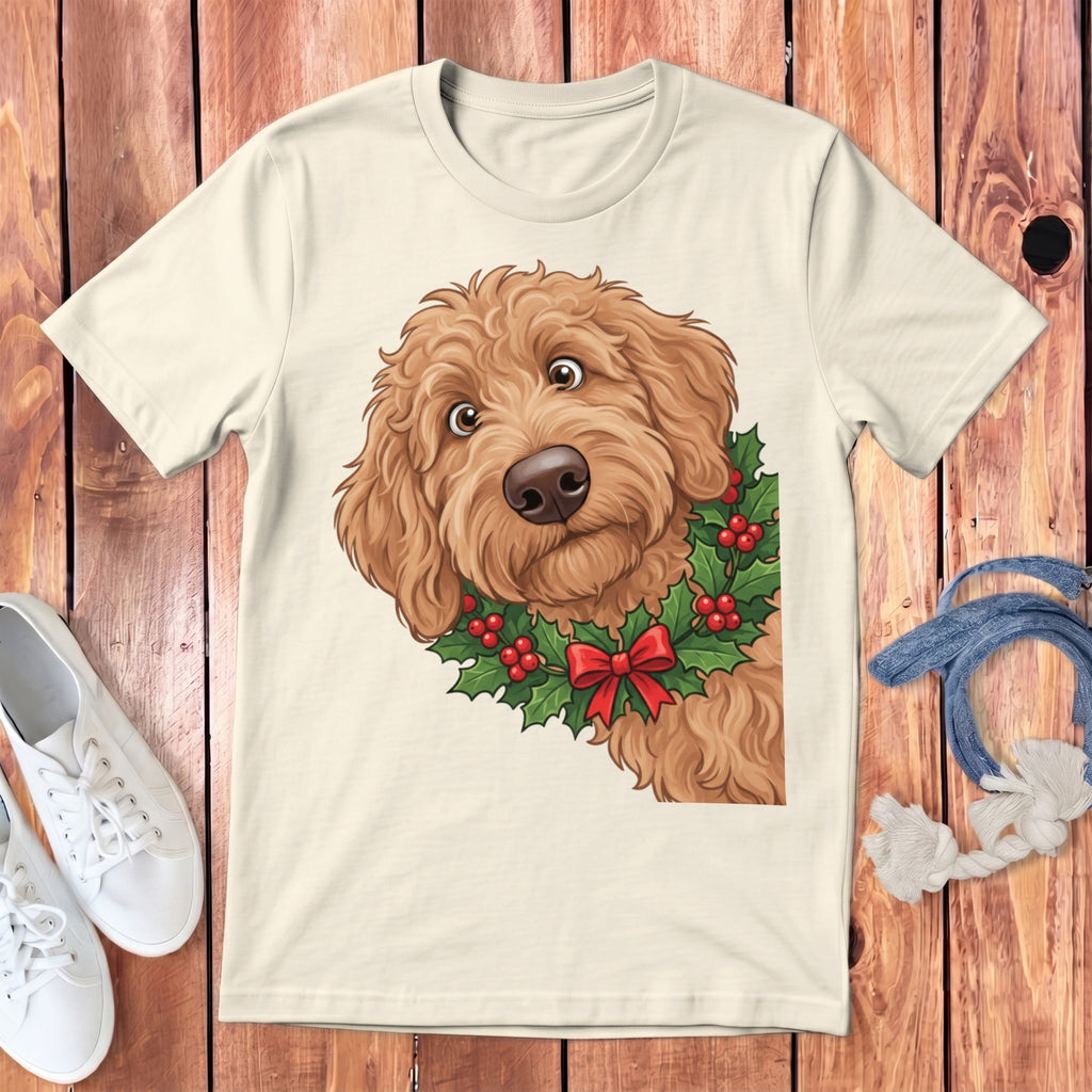 Cream t-shirt with a cartoon goldendoodle wearing a holly wreath and red bow.
