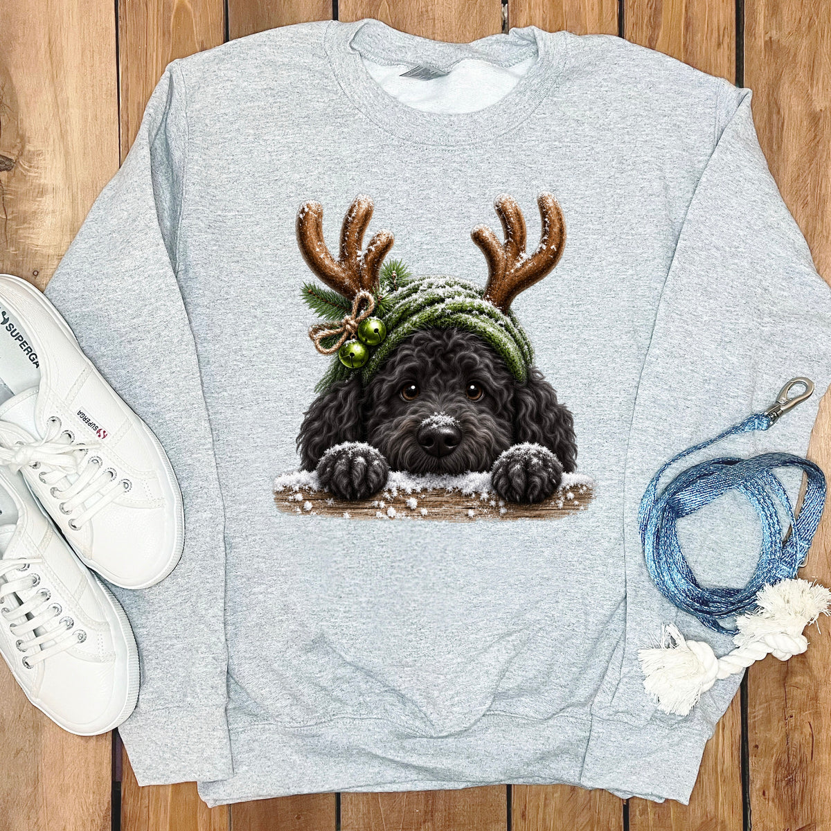 Gray sweatshirt with a black dog wearing antlers and a green hat.
