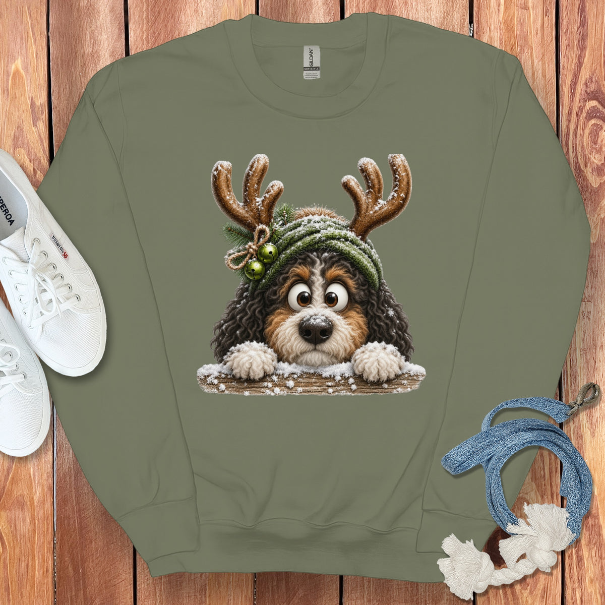 Green sweatshirt with a cartoon dog wearing antlers and a green hat.