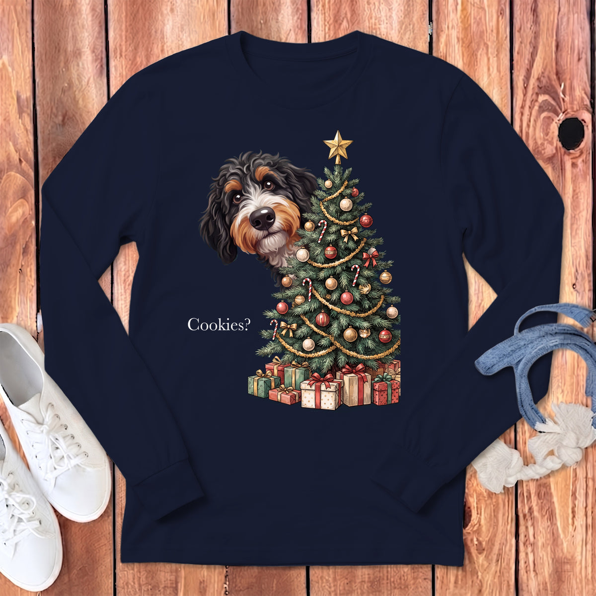 Bernese Mountain Dog peeking by a Christmas tree with presents and text "Cookies?".