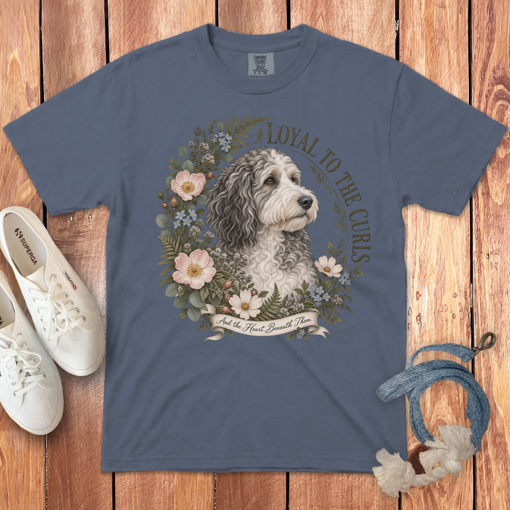 Blue t-shirt with a dog illustration surrounded by flowers and text.