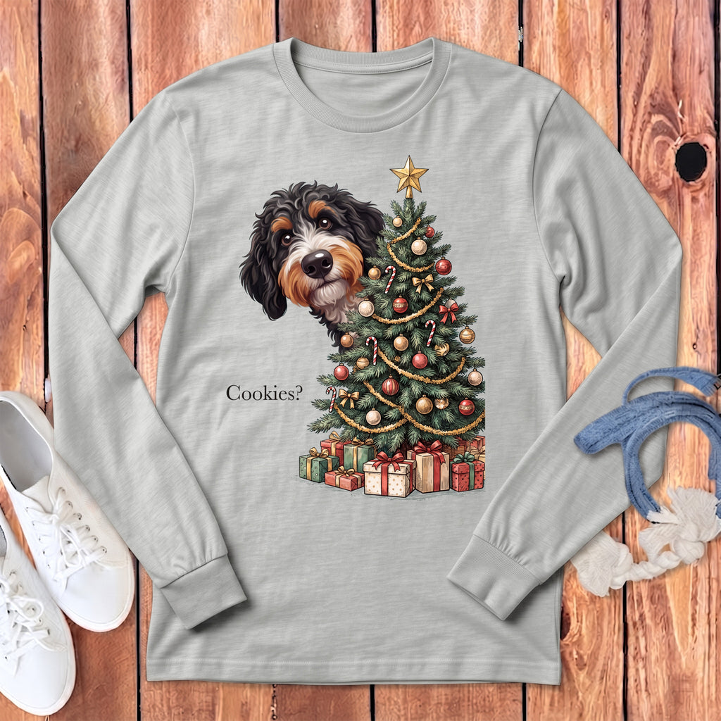 Bernese Mountain Dog peeking from behind a Christmas tree with presents.