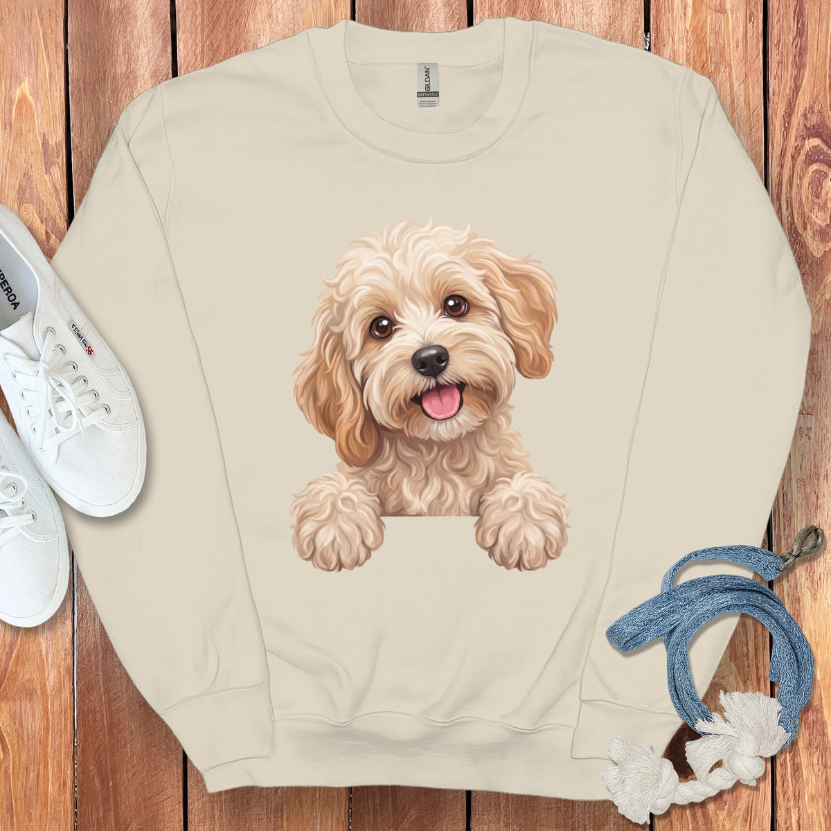 Cream sweatshirt with a happy, fluffy dog graphic and white sneakers.