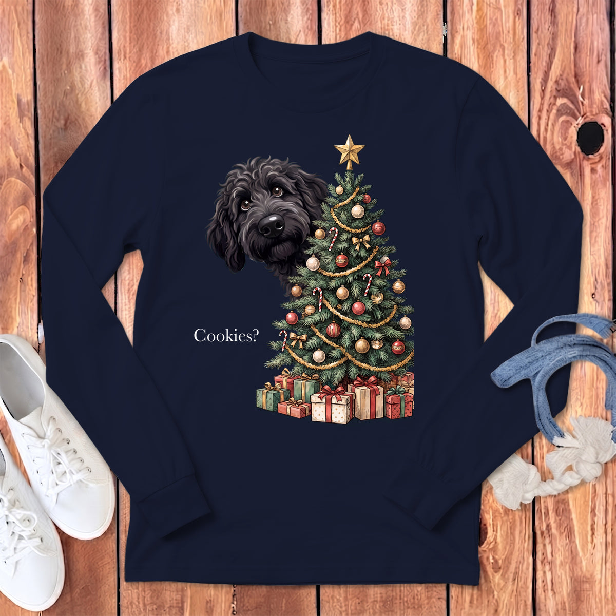 Black dog peeking behind a decorated Christmas tree with presents and text "Cookies?".