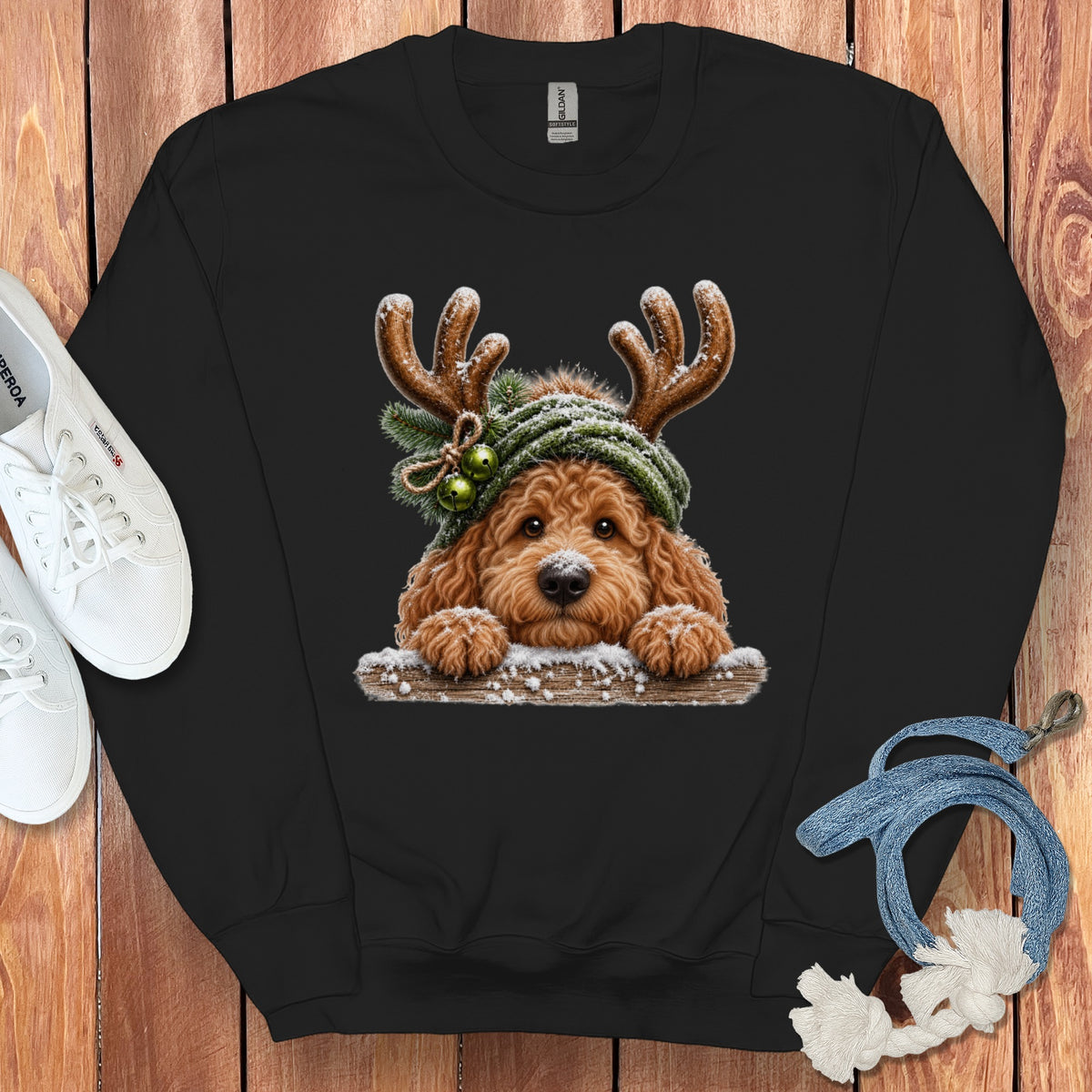 Black sweatshirt with a doodle dog wearing antlers and a green hat with bells.