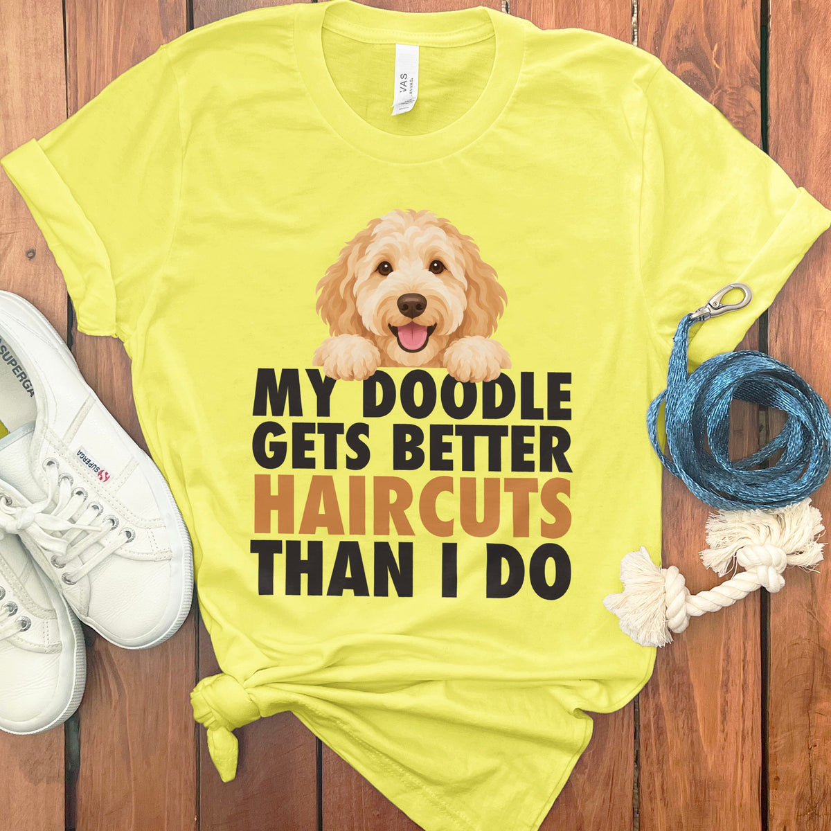Yellow t-shirt with a doodle dog and text "My Doodle Gets Better Haircuts Than I Do".