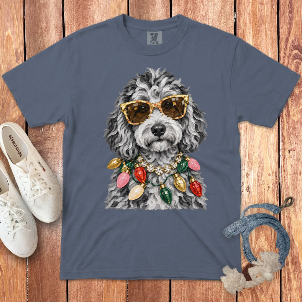 Dog wearing sunglasses and a Christmas light necklace on a grey t-shirt.