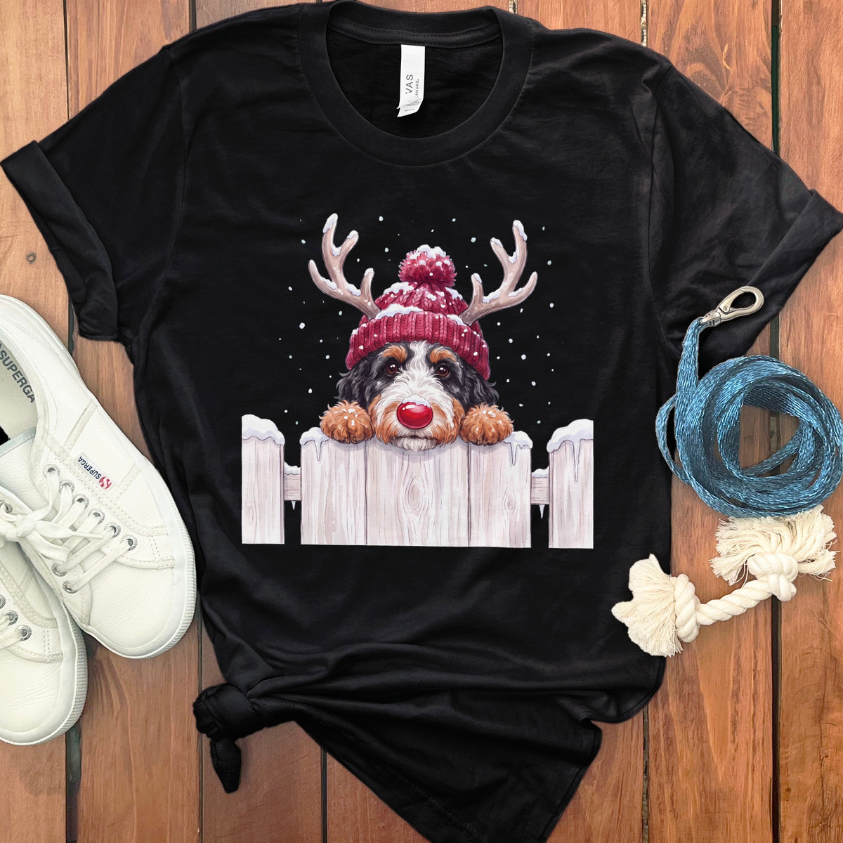 Black t-shirt featuring a Bernese Mountain Dog wearing a Rudolph nose and reindeer antlers.