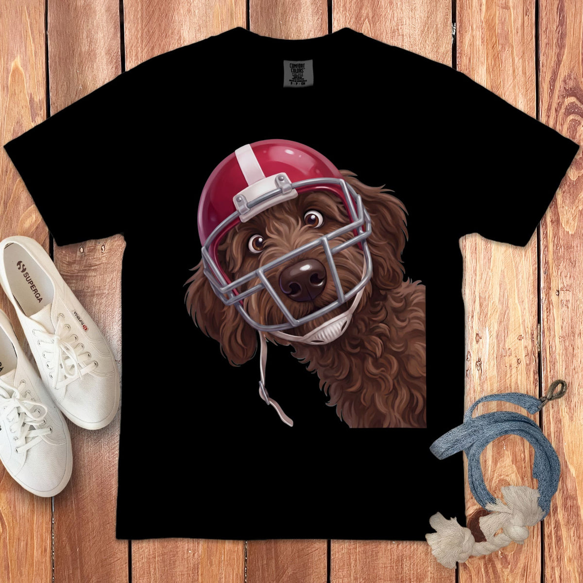 Brown doodle dog wearing a red football helmet on a black t-shirt.