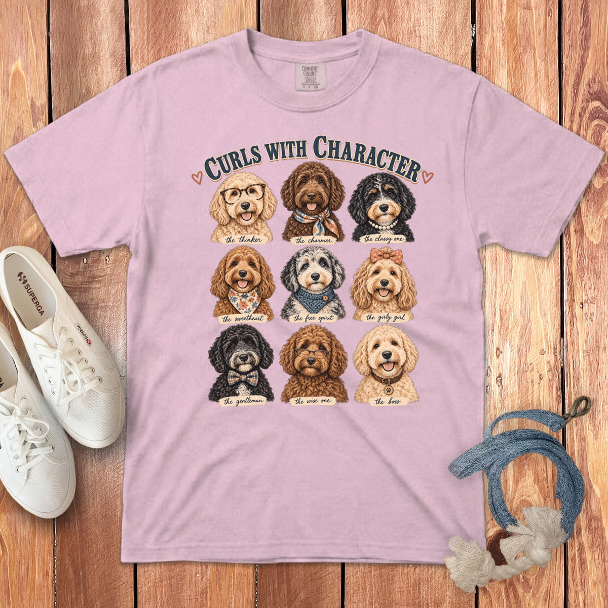 Pink t-shirt with "Curls With Character" and nine illustrations of dogs with different descriptions.