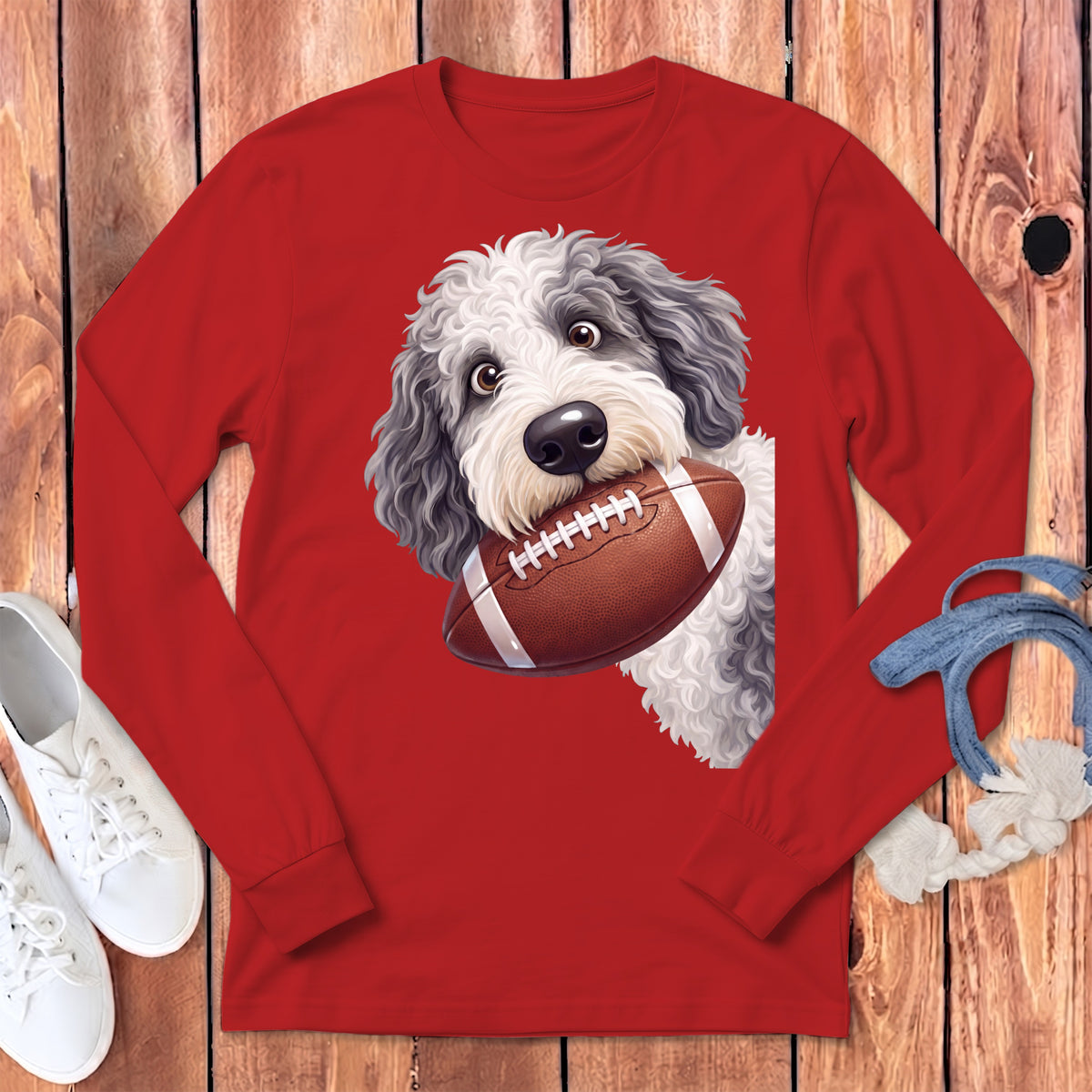 Red long-sleeve shirt with a cartoon dog holding a football.