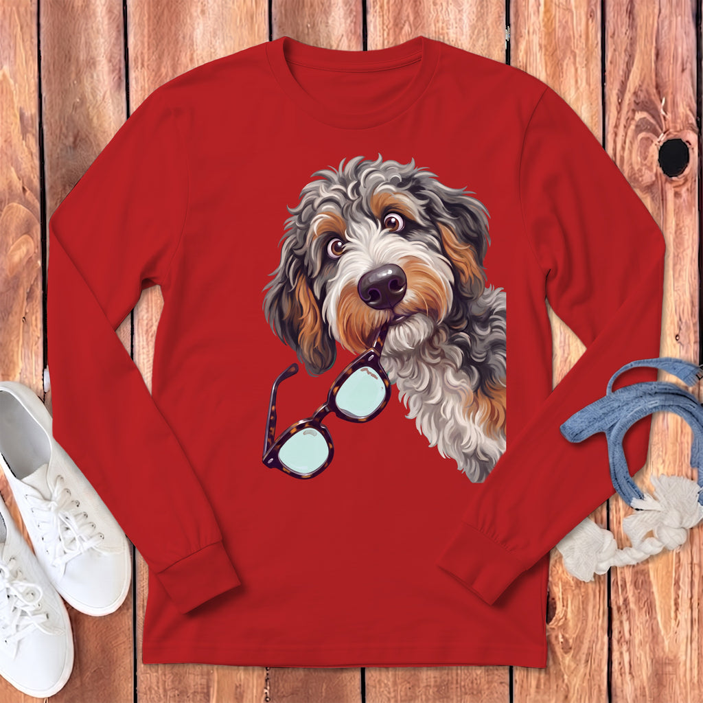 A red long-sleeved t-shirt featuring a graphic of a shaggy dog holding glasses in its mouth.