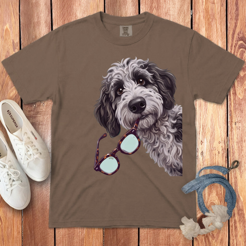 Brown crewneck t-shirt featuring a graphic of a shaggy black-and-white dog holding glasses in its mouth.