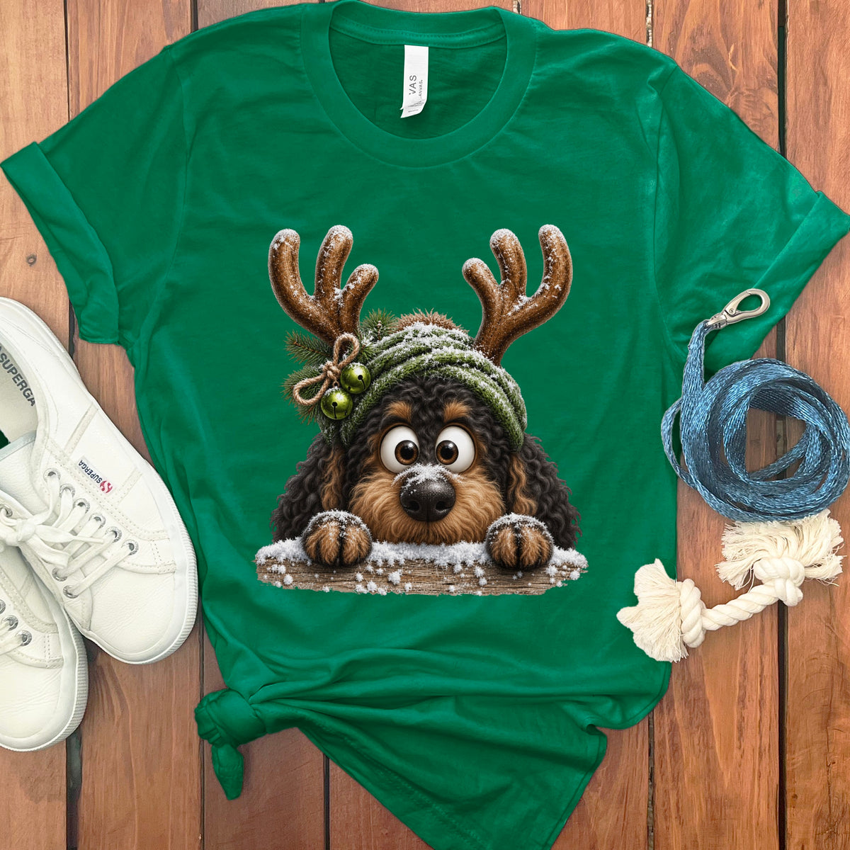 Green t-shirt with a cartoon dog wearing reindeer antlers and a green knit hat.