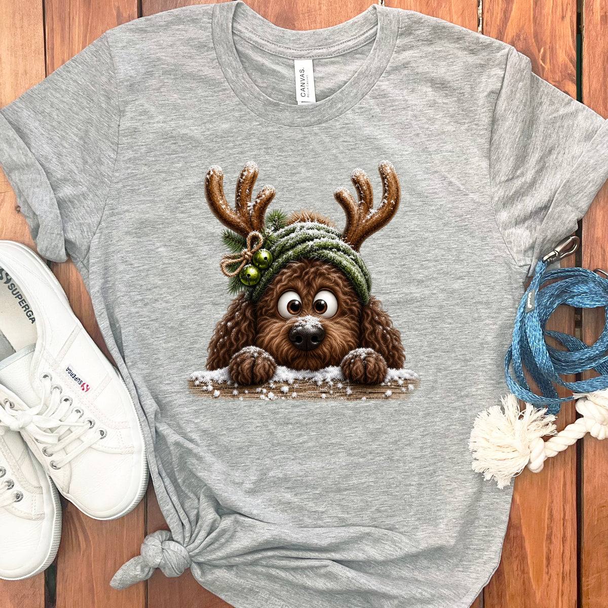Grey t-shirt with a cartoon dog wearing reindeer antlers and a winter hat.