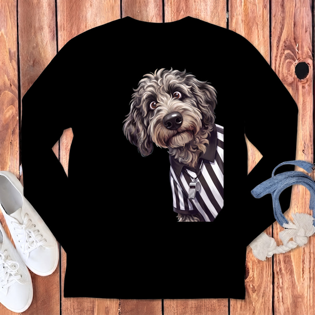 Fluffy dog wearing referee stripes and a whistle necklace on black long-sleeve shirt.