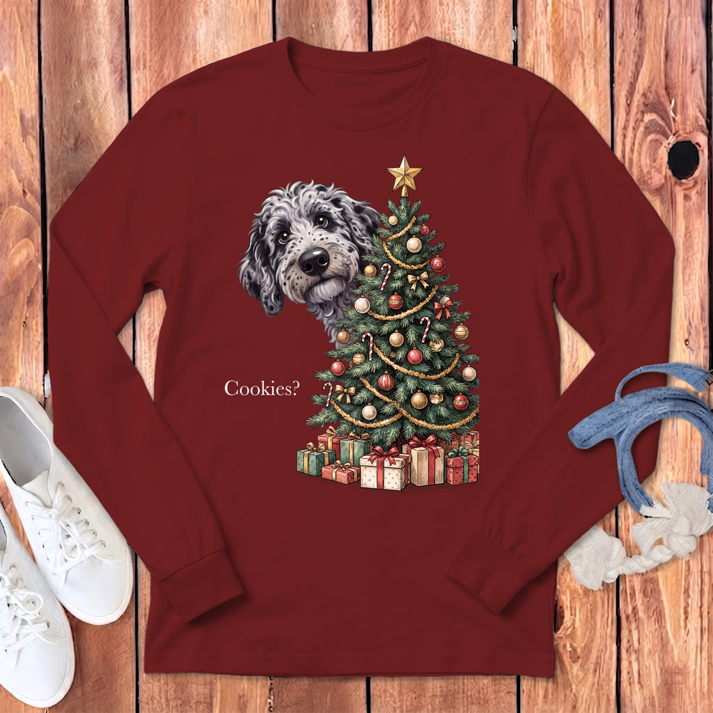 Maroon long-sleeve shirt with a doodle peeking from behind a Christmas tree.