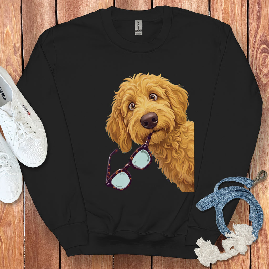 Black crewneck sweatshirt featuring a graphic of a golden doodle dog holding glasses in its mouth.